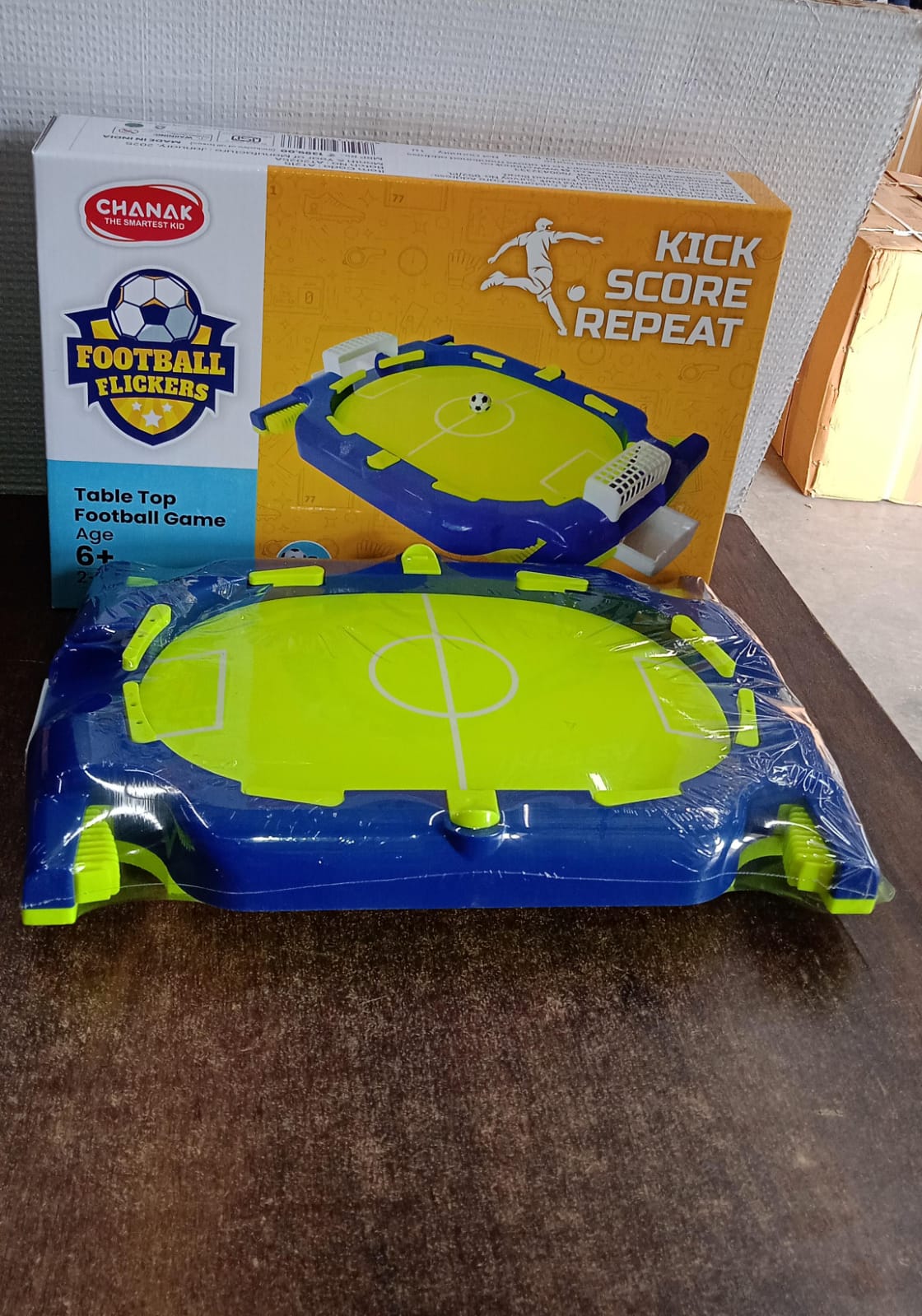 Kids playing multiplayer tabletop football flickers indoor game