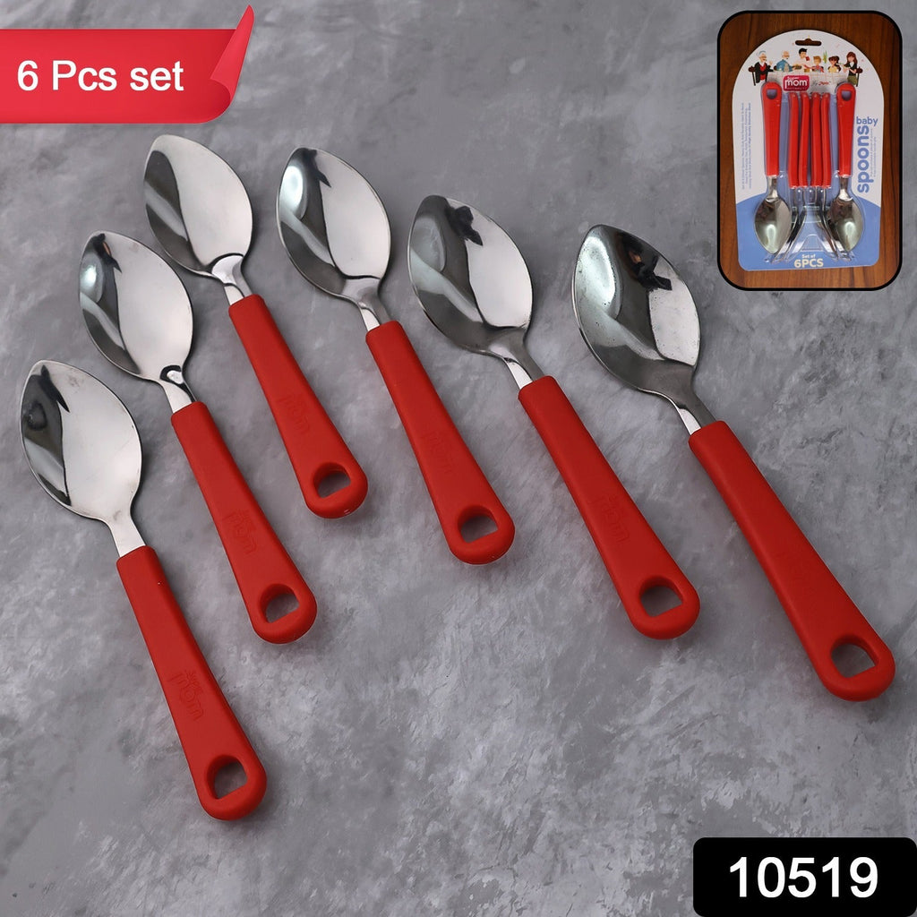 Close-up of plastic handle on baby feeding spoon in stainless steel set