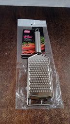 Neutral kitchen image showing stainless steel grater tool