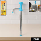 Using manual oil pump dispenser pouring cooking oil in kitchen