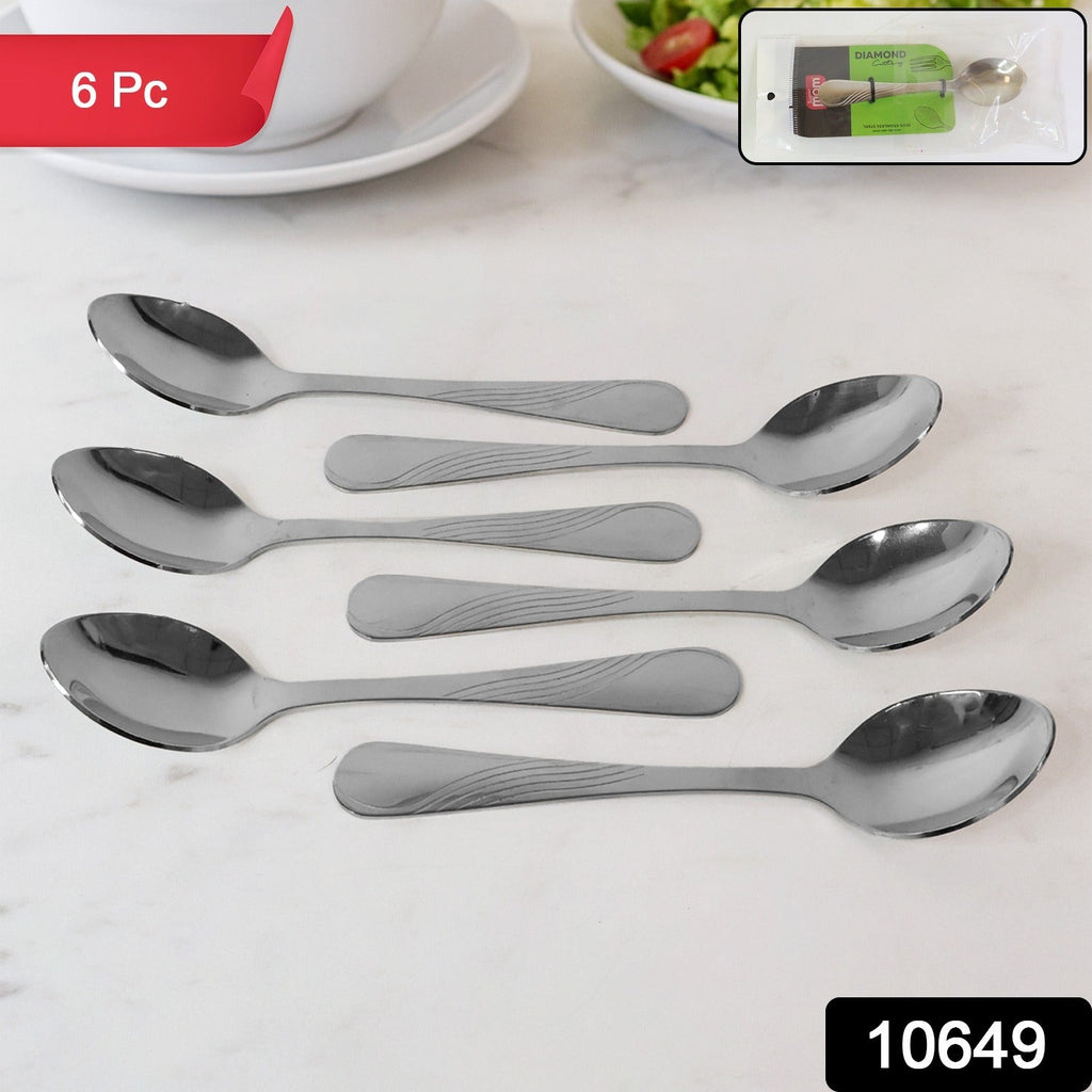 Stainless steel spoons neatly arranged on a white background, showcasing their polished finish