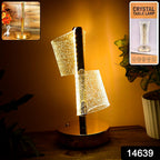 Modern crystal table lamp with warm LED lighting on a wooden surface