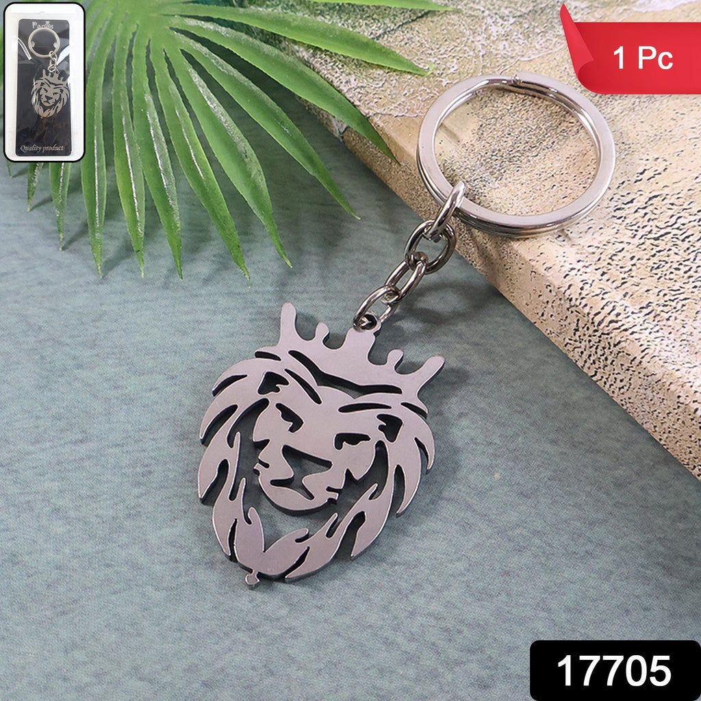 Stylish metal lion head keychain with crown placed on a wooden surface
