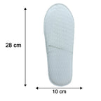 Folded white disposable slippers for travel and hotel use