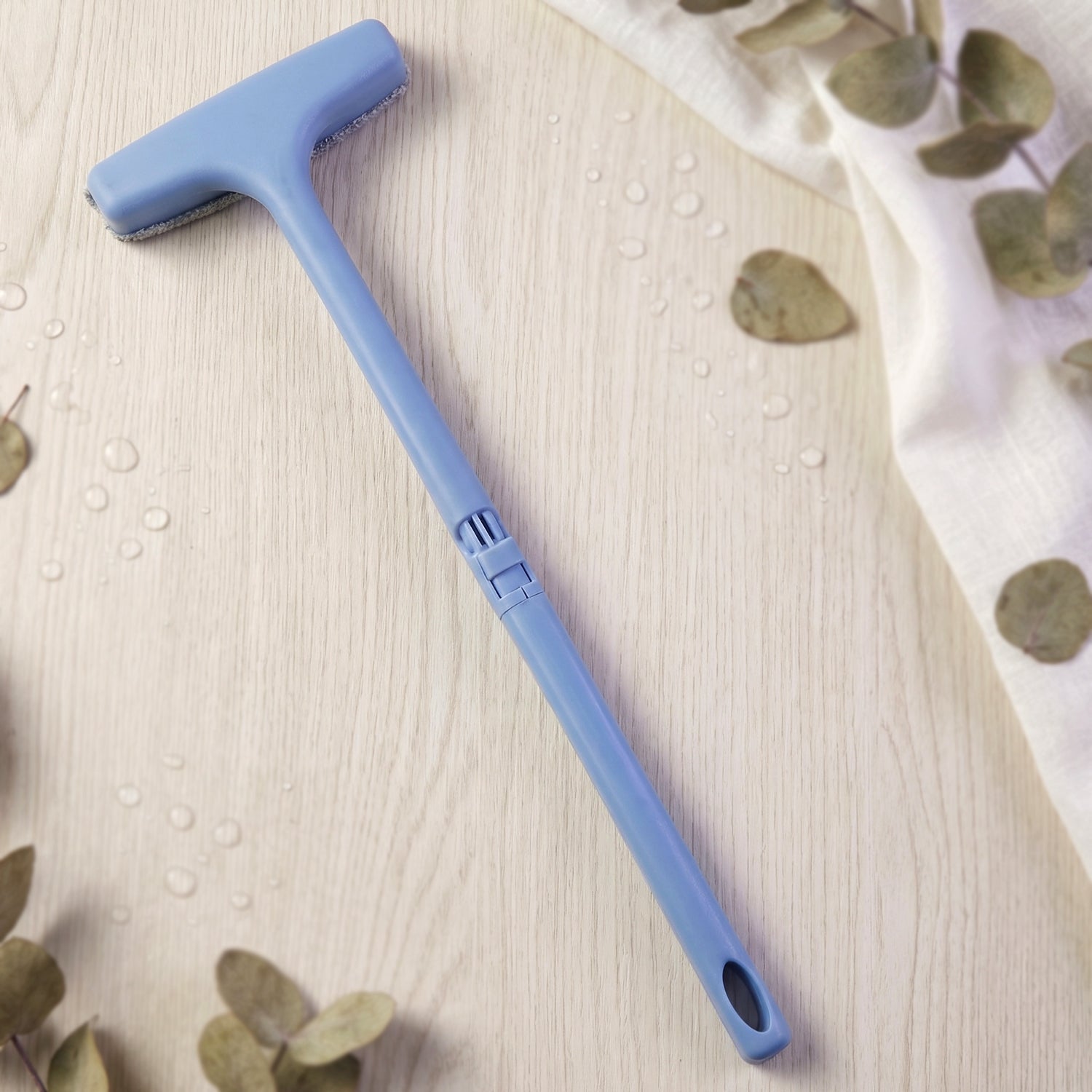 The soft bristles of the window mesh cleaner gently cleaning delicate screen surfaces.