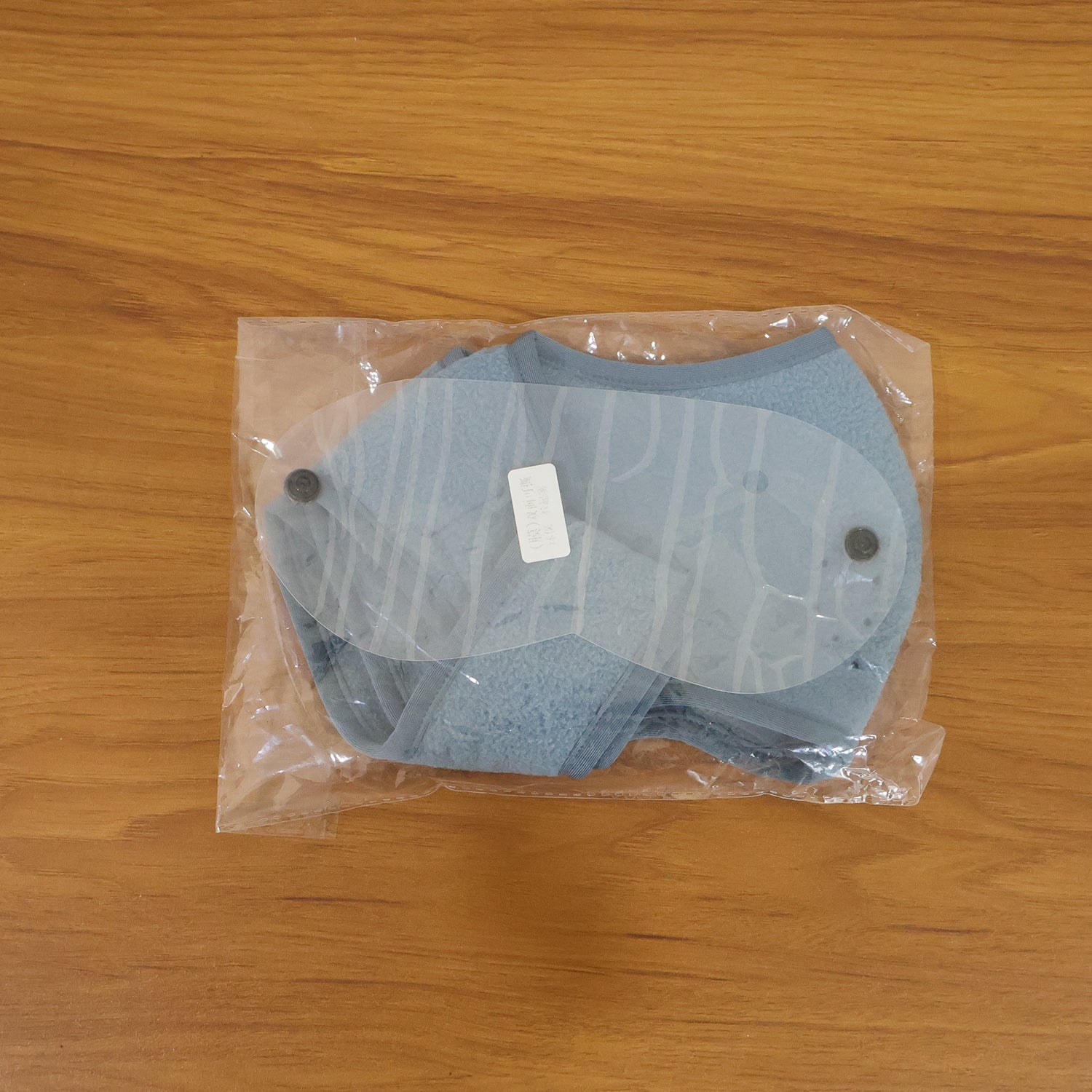 Model wearing reusable face mask with clear eye shield for safety
