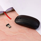 Wireless Mouse displayed next to a hand to show its ultra-thin profile and ergonomic fit.