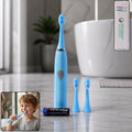 A white battery operated electric toothbrush standing upright with its brush head.