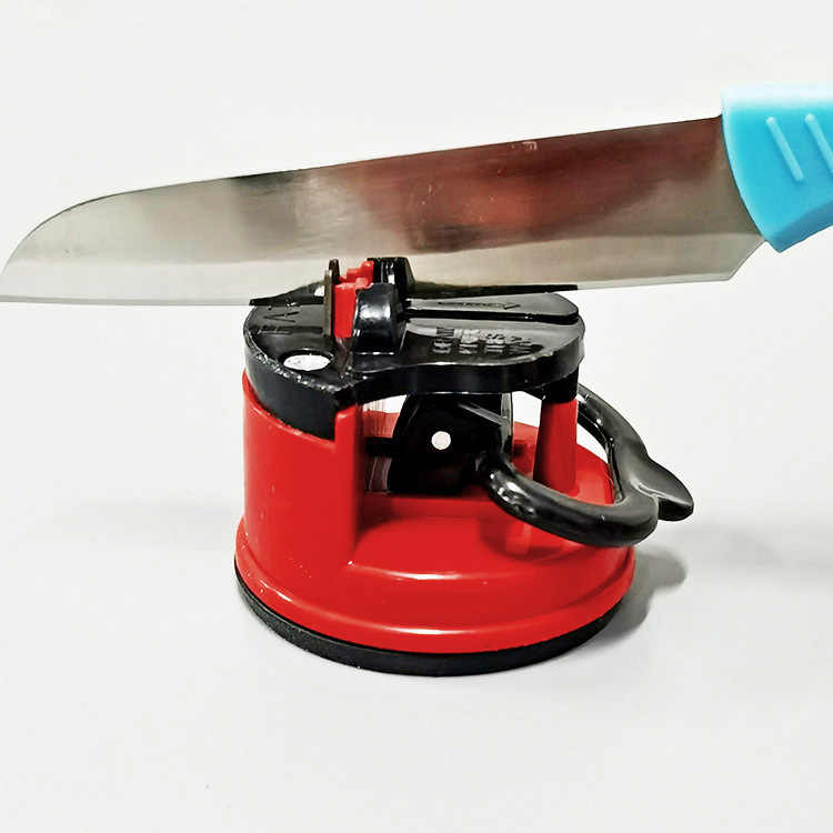 Manual knife sharpener featuring a robust suction cup base for stability.