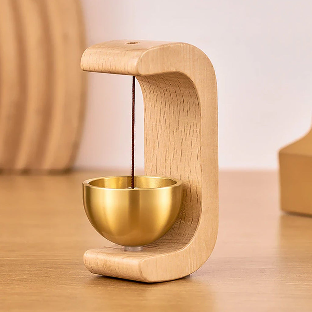Detailed view of wooden stand and brass chime ball of Zen bell