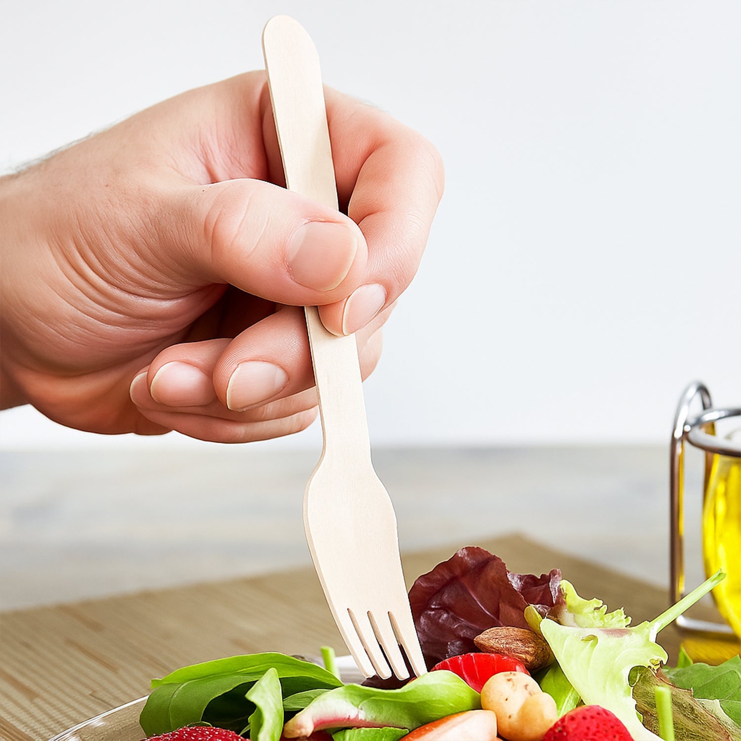 Hand holding a Freshee 160mm eco-friendly birchwood wooden fork