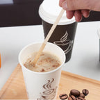 Wooden coffee stir sticks stored in a holder ready for use