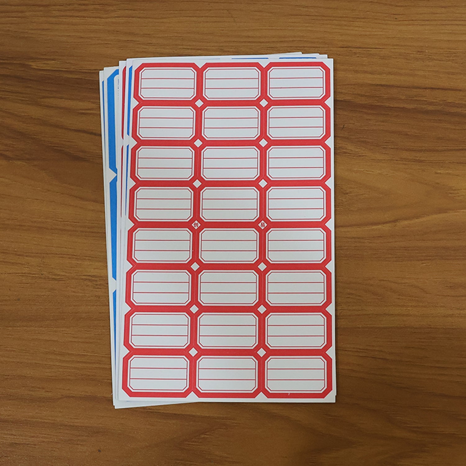 Backing side of writable label stickers showing strong adhesive layer
