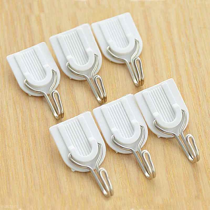 Damage-free self-adhesive hook securely holding multiple towels.