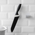 A sleek black punch-free wall hanging knife holder mounted on a kitchen wall, showcasing its modern design and space-saving functionality.