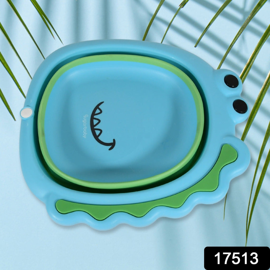 A child's hands being washed in the cute frog design foldable baby wash basin.