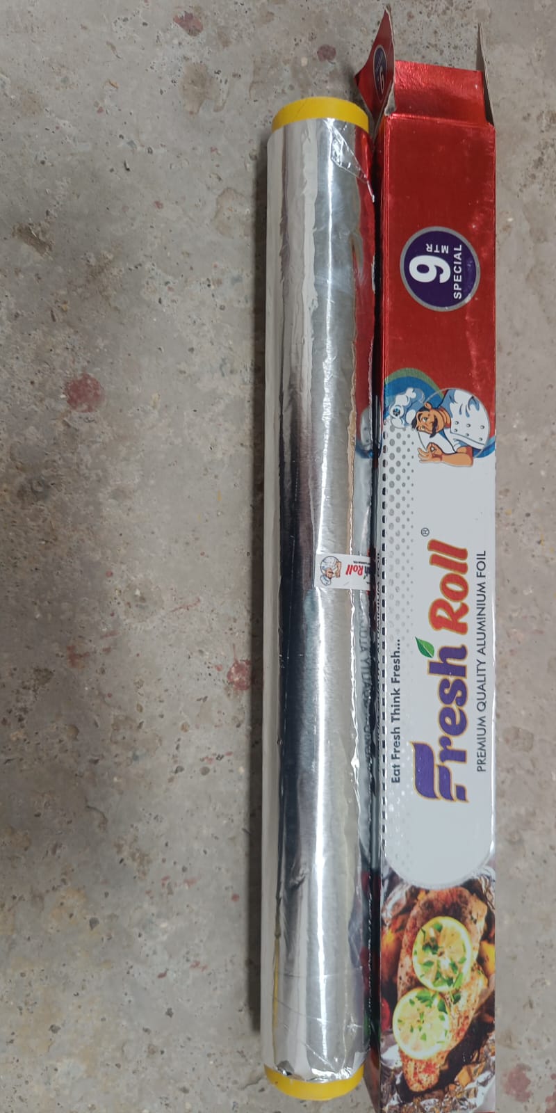 Aluminum foil roll with natural cutter for easy dispensing.