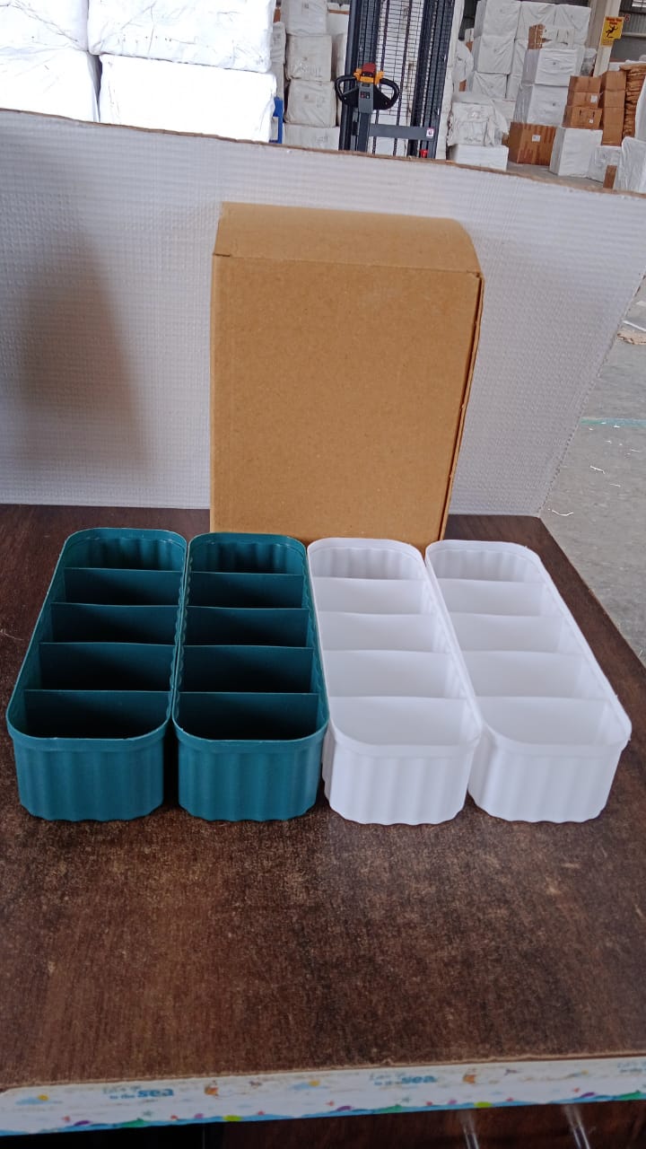 Display of 5-compartment drawer organizers in assorted vibrant colors.