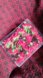 Packaging of the 12-piece red rose hair clip set, ideal for gifting.