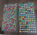 Display of multi-size self adhesive crystals for diverse art and craft projects.