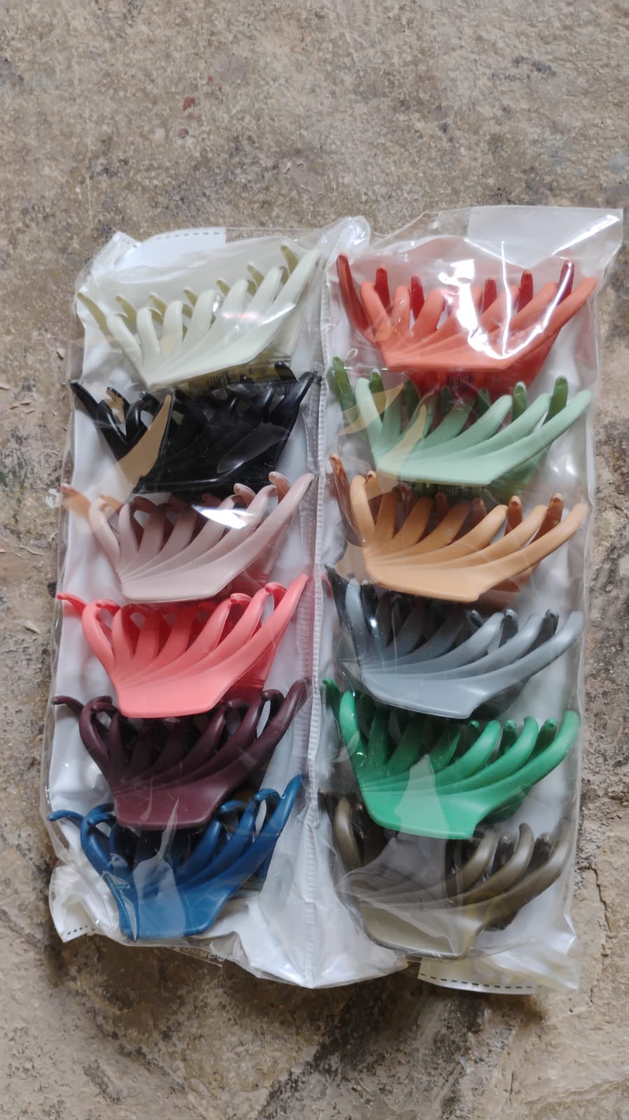 Vertical display of matte plastic hair clamp showing compact size