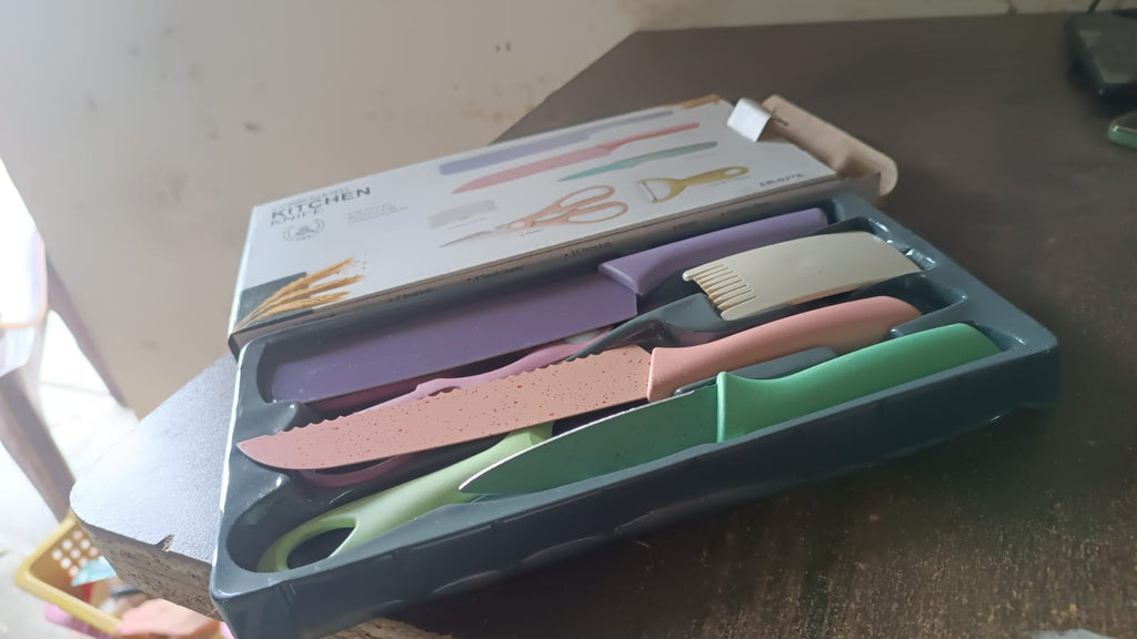 Detailed view of the high carbon steel blades and ergonomic colourful handles of the knife set.