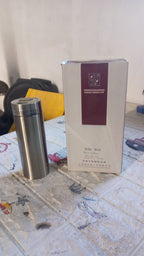 The stainless steel flask shown with its brand packaging.