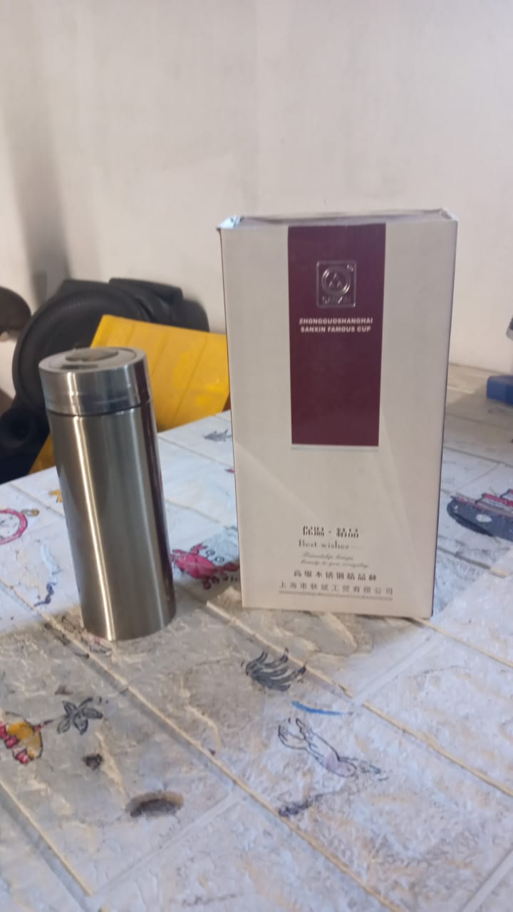 The stainless steel flask shown with its brand packaging.