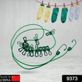 FERVENT portable clothes drying rope stretched out, holding various garments.