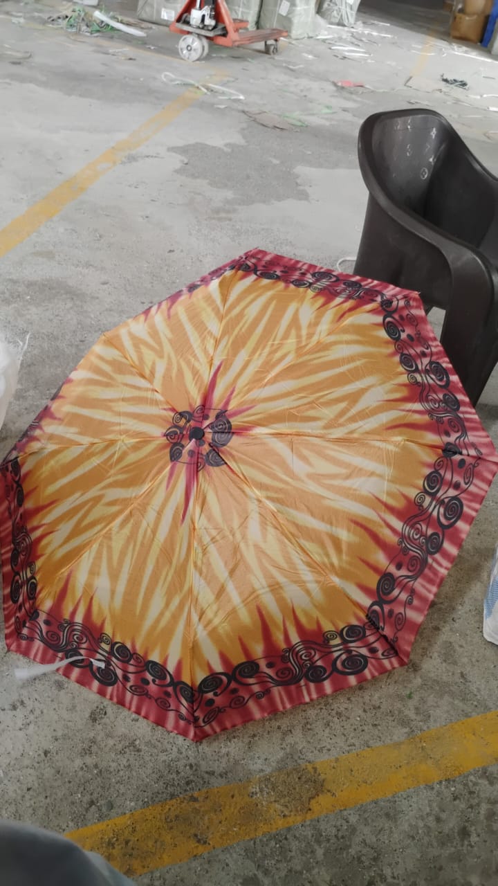 Person outdoors holding 3-Fold foldable umbrella for sun and rain protection