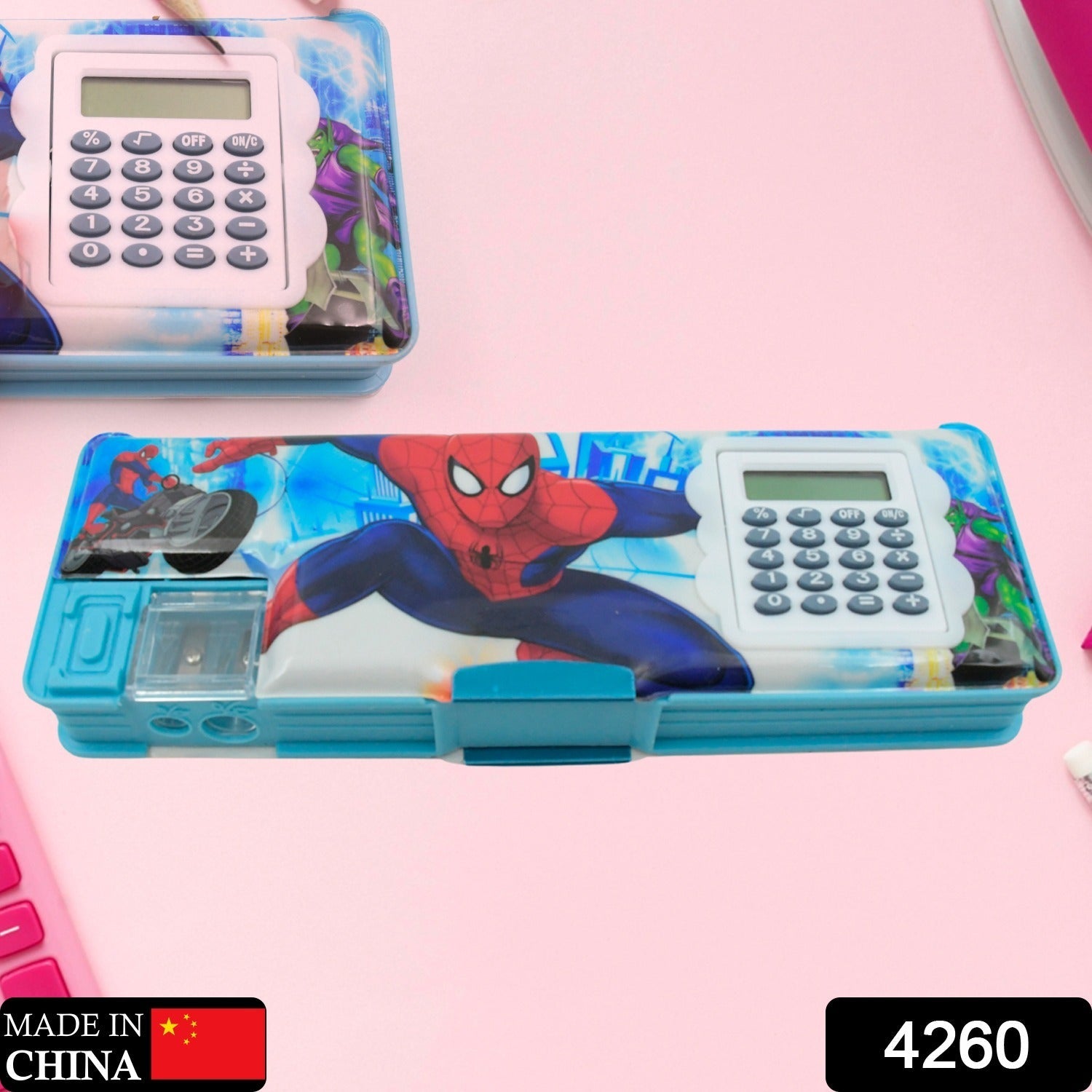 Open geometry box showing calculator, double sharpener, and organized compartments.
