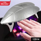 Hand with gel nails curing under the portable Mini UV LED nail lamp at home.