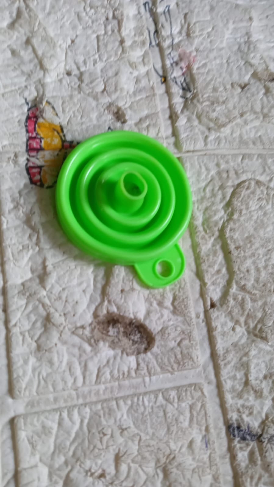 A single red silicone funnel on a clean white background.