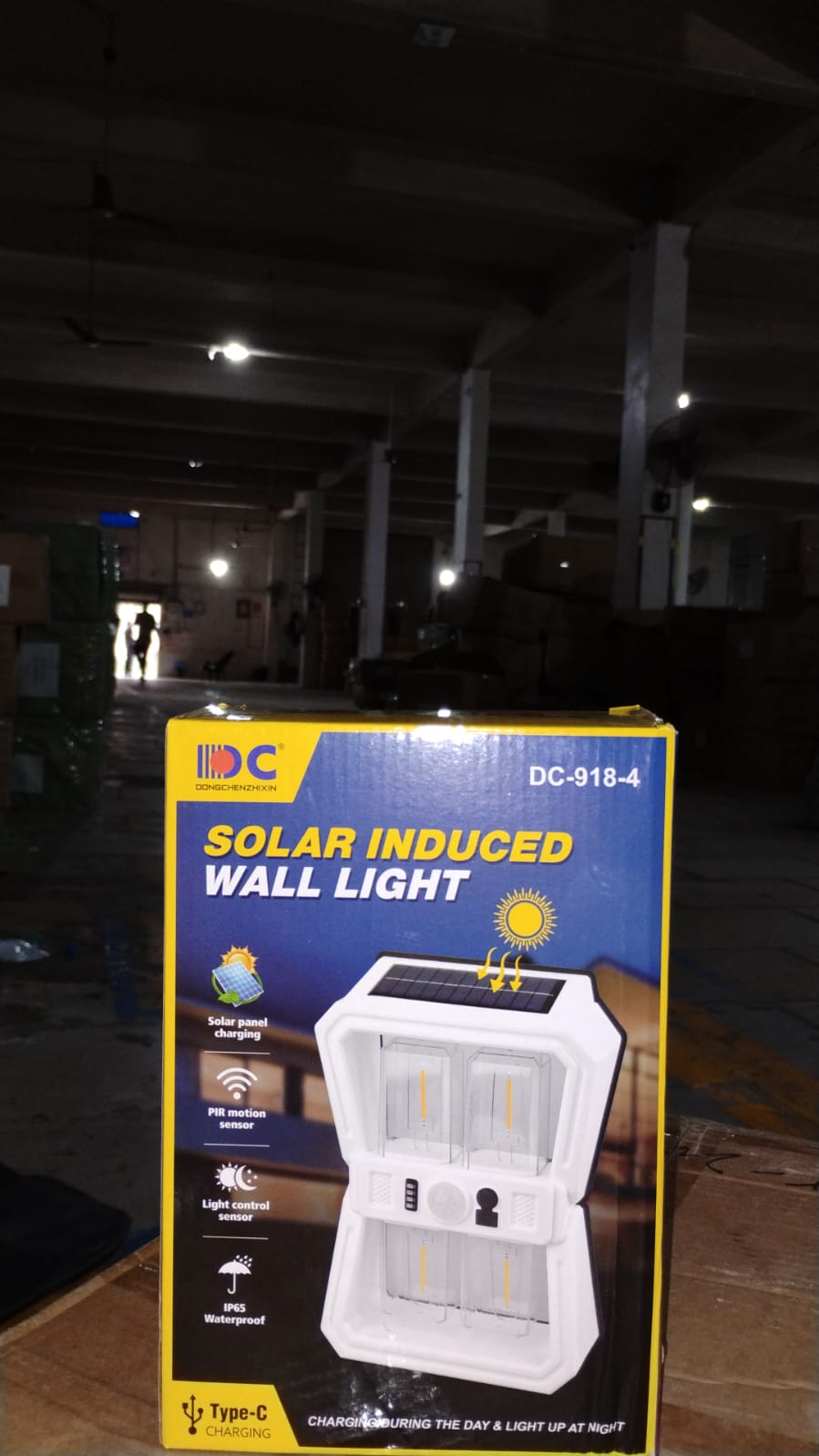 The solar panel on top of the wall lantern absorbing sunlight for charging.