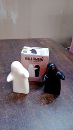 Styled image of modern ceramic salt and pepper shakers in couple hug