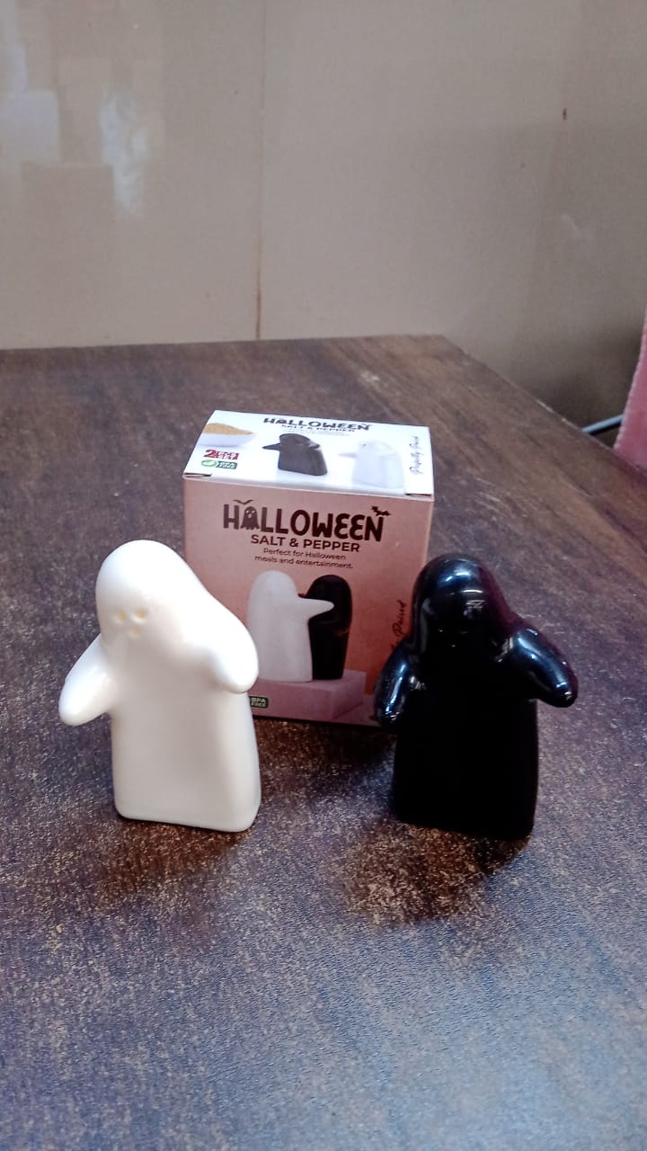 Styled image of modern ceramic salt and pepper shakers in couple hug