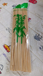 Colorful vegetables and chicken pieces prepared on bamboo shish kabob sticks.