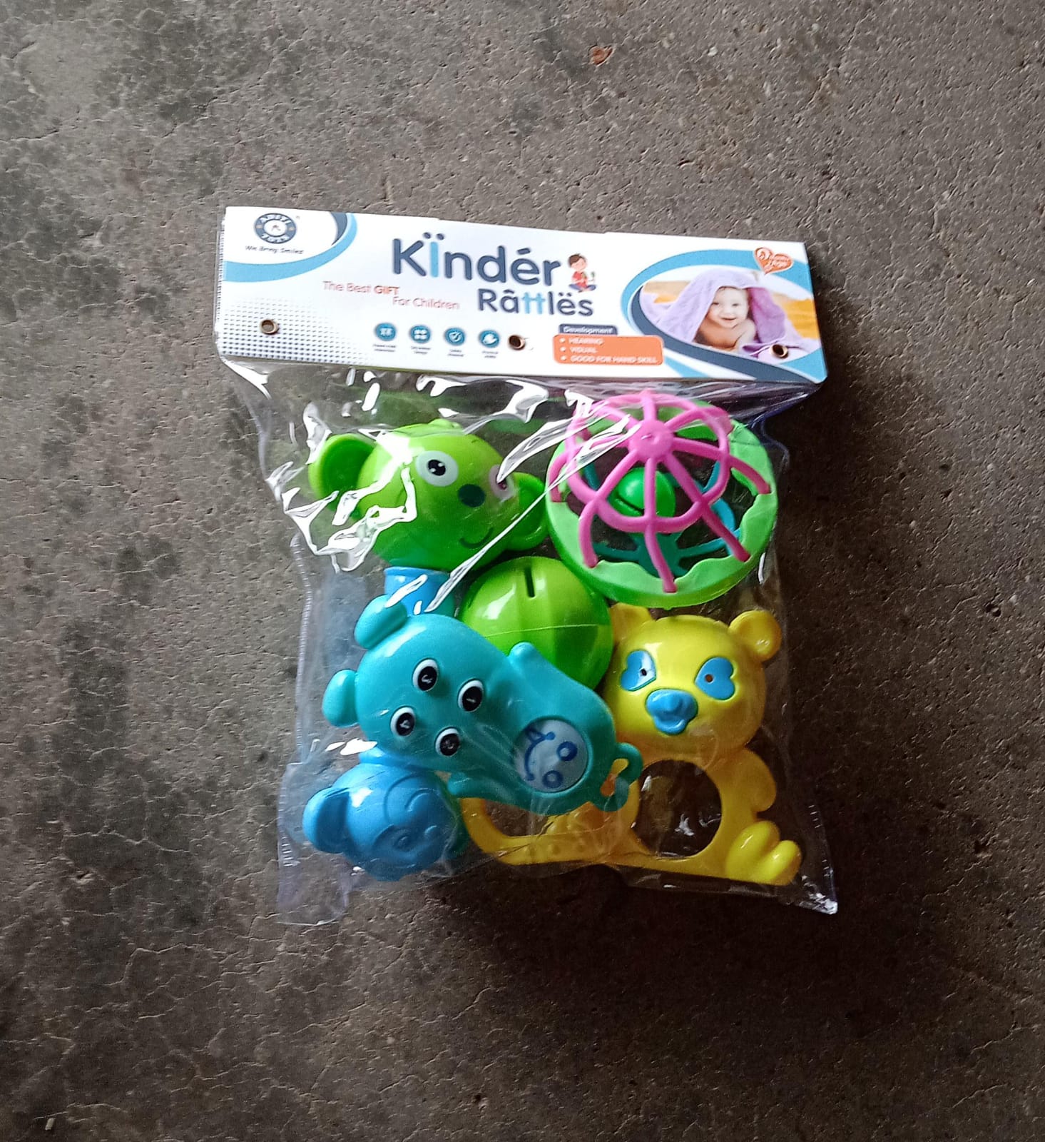 Overhead view of the 5-piece Aditi rattles baby toy collection.