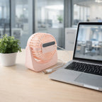 Portable silent small desk fan near a laptop for personal use