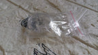 Silicone magnetic nose clip resting on surface before use