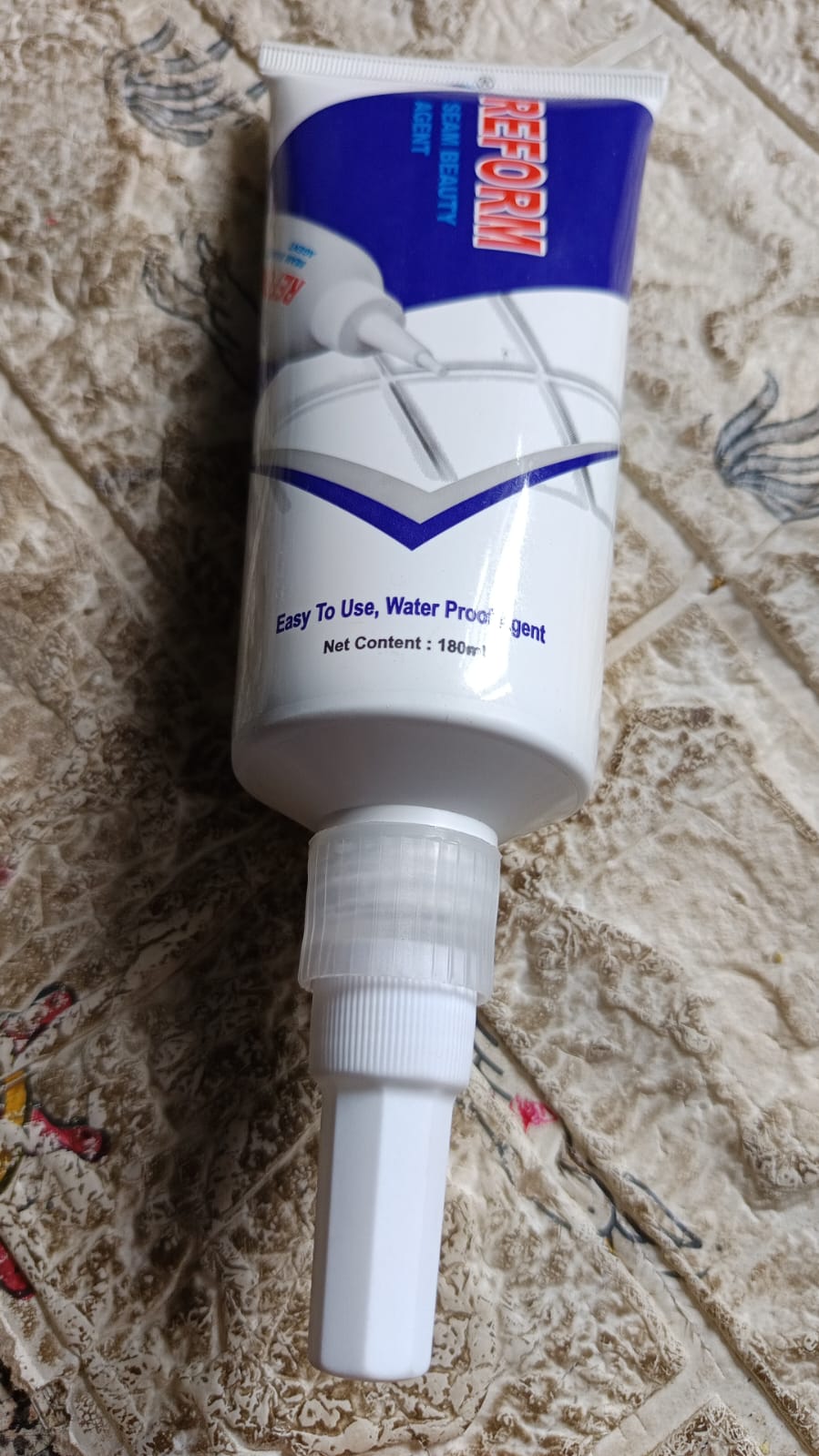 White Waterproof Tile Gap Filler being applied to a tile surface, demonstrating easy use.