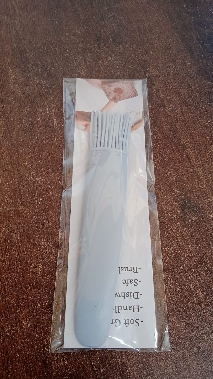 Silicone pastry brush ready for use in a modern kitchen setting.