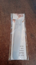 Silicone pastry brush ready for use in a modern kitchen setting.