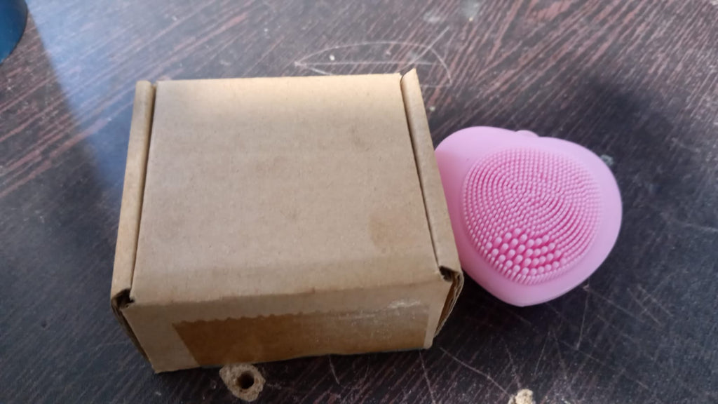 Silicone exfoliating face brush in heart shape for women.