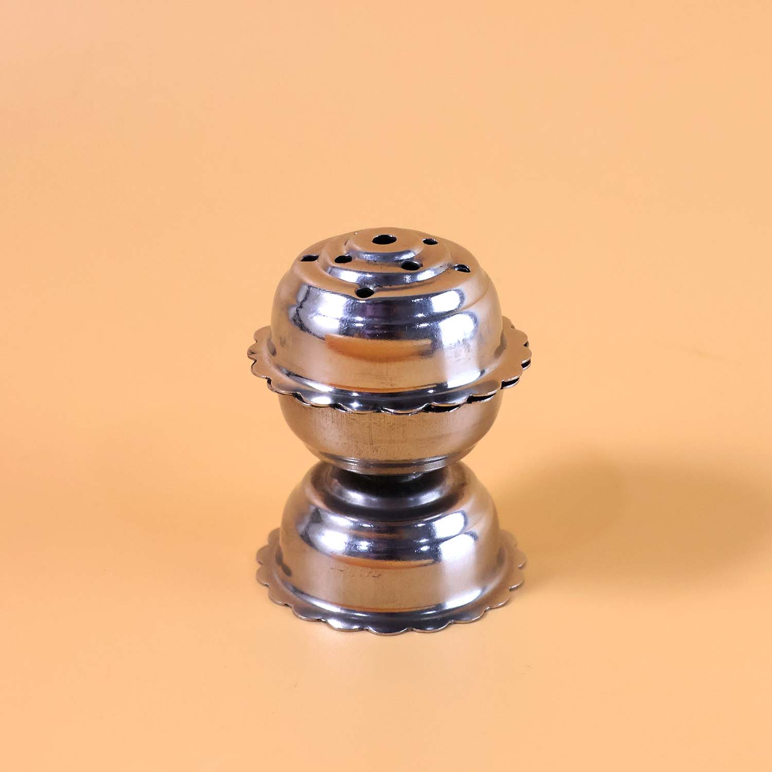 Durable stainless steel agarbatti stand with multiple slots.
