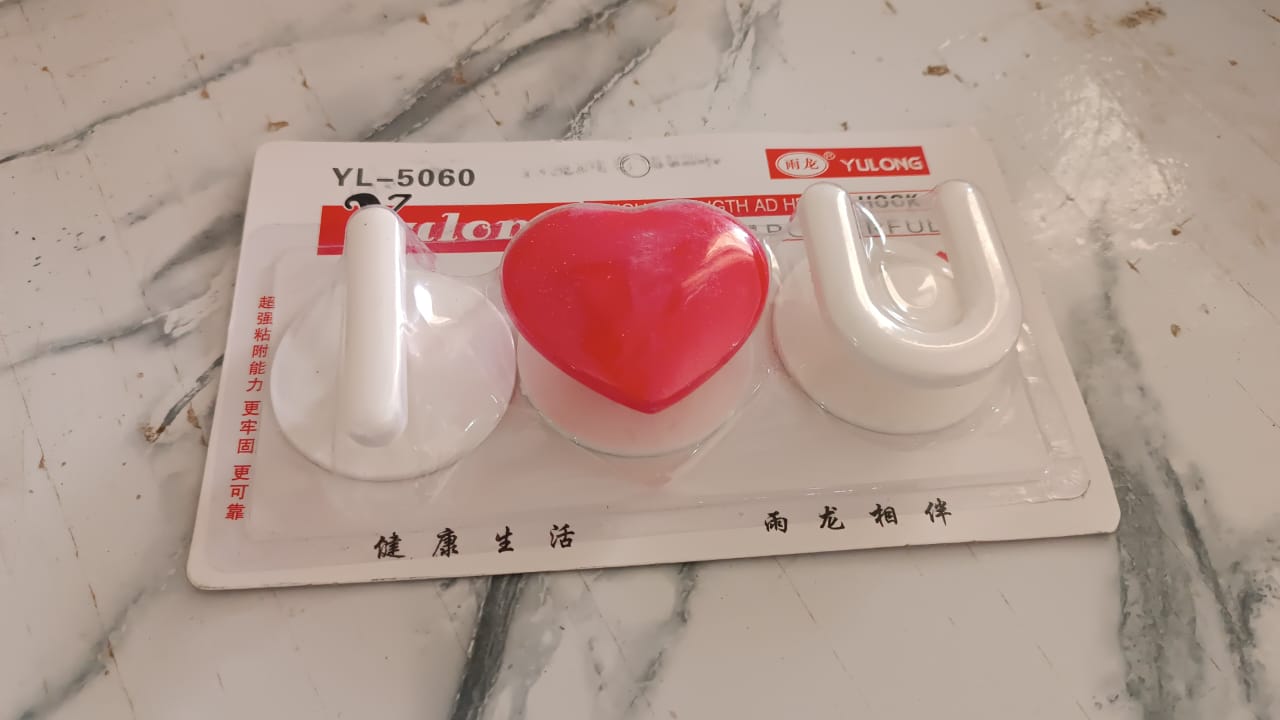 Multi-purpose adhesive hooks mounted on tile and glass surfaces