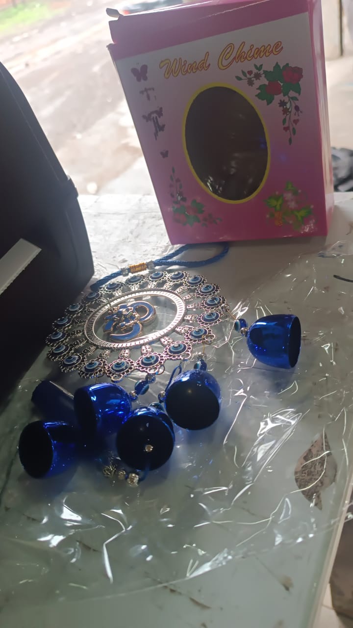 Close-up of protective charms on Om Evil Eye wind chime