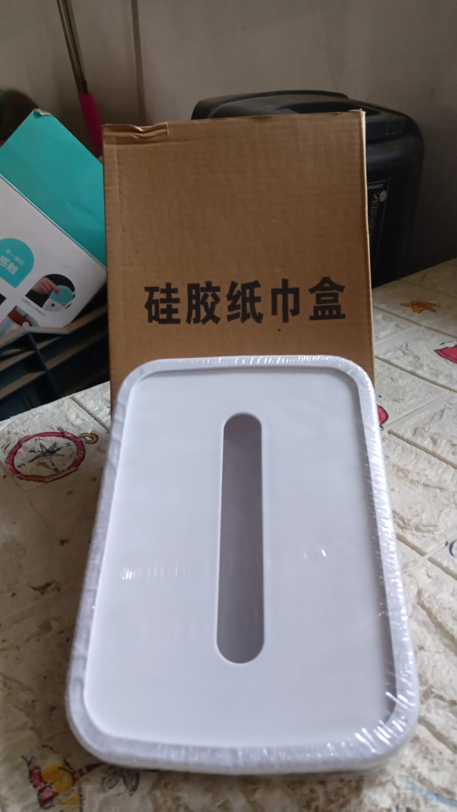 Silicone tissue holder being folded to showcase its flexibility.