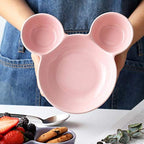 Top-down view of a colorful Mickey shaped kids plate for snacks.