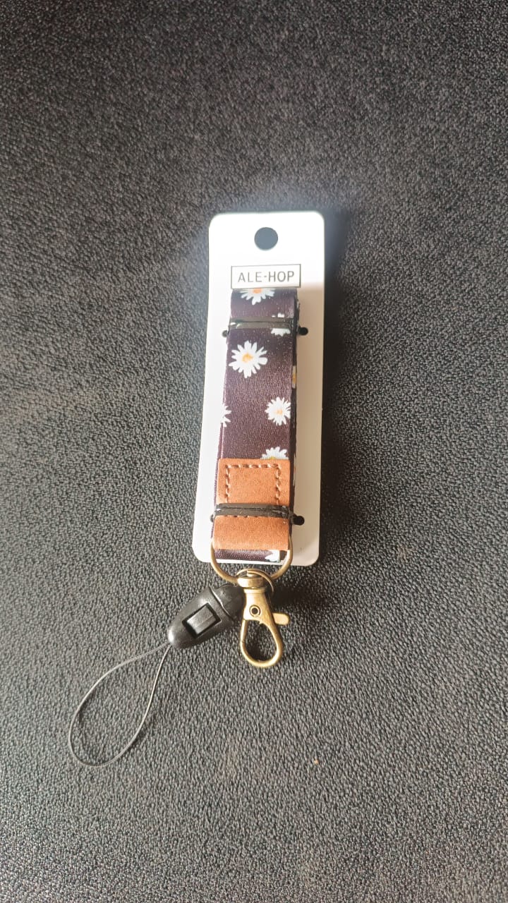 Close-up of floral print fabric neck lanyard with leather patch
